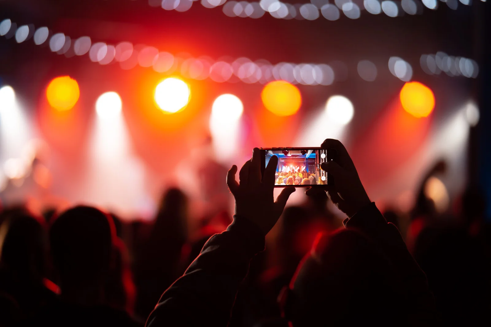Concert crowd filming the stage